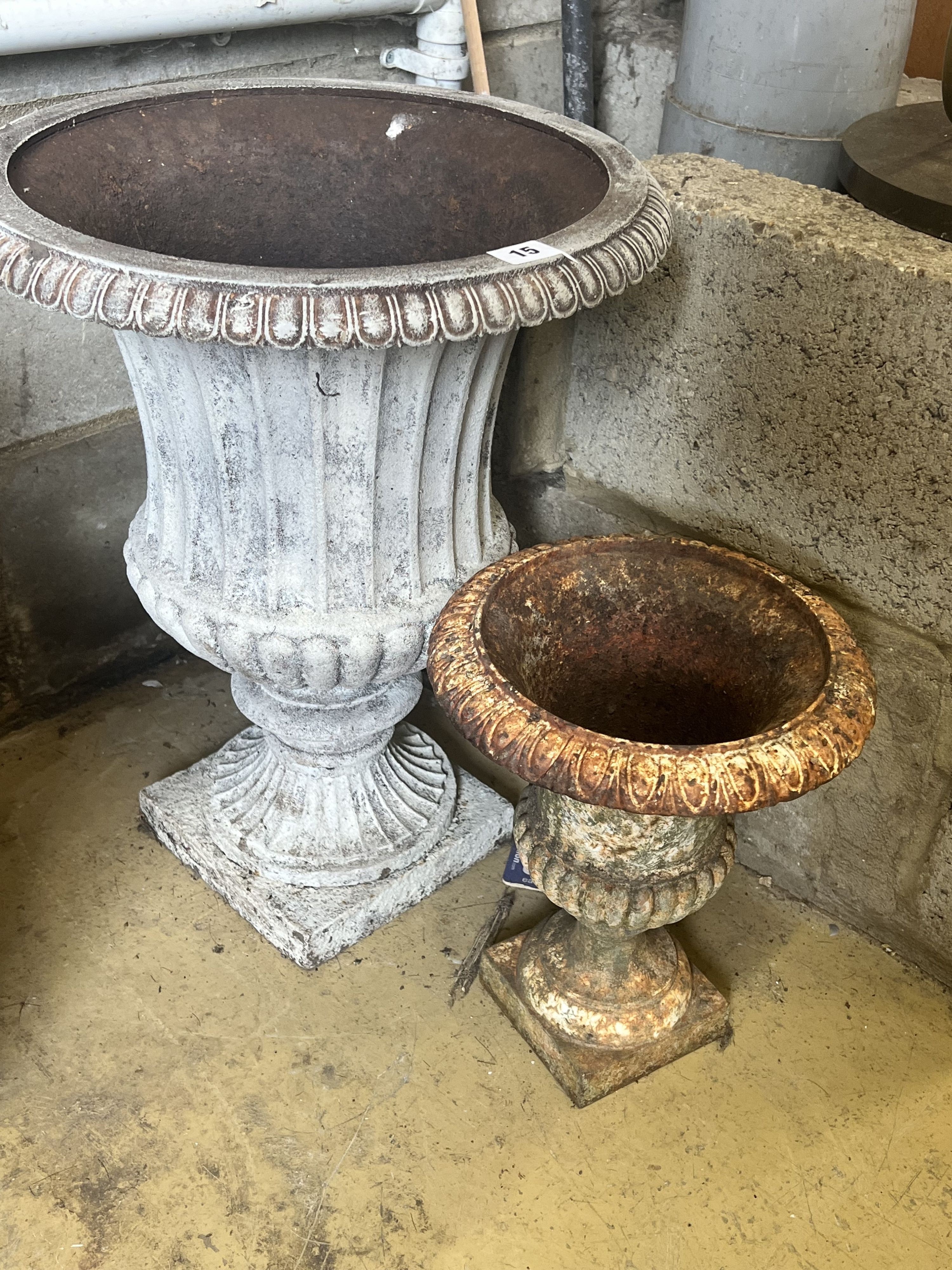 A pair of cast iron campana garden urns, larger diameter 39cm height 48cm